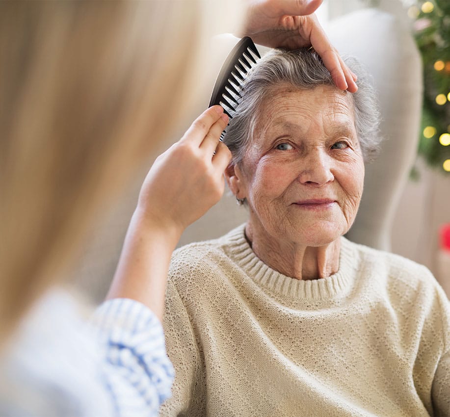 senior woman getting hair combed