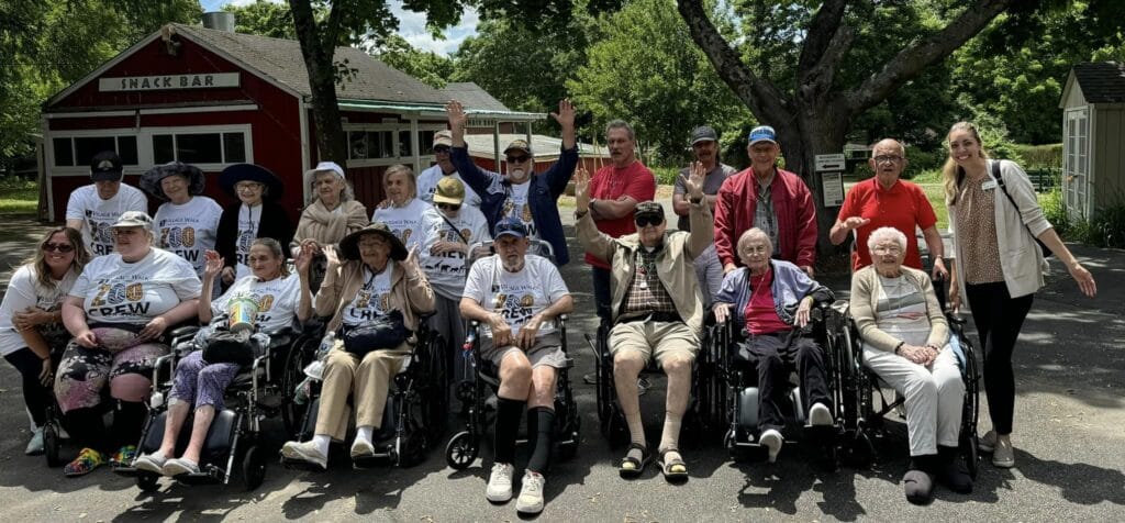 A group of people with dementia smiling for the camera