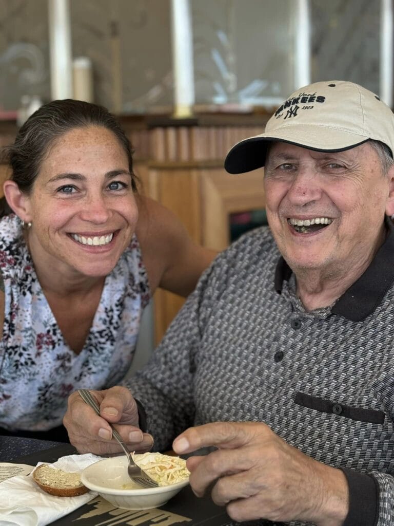 A woman smiling with an elderly person