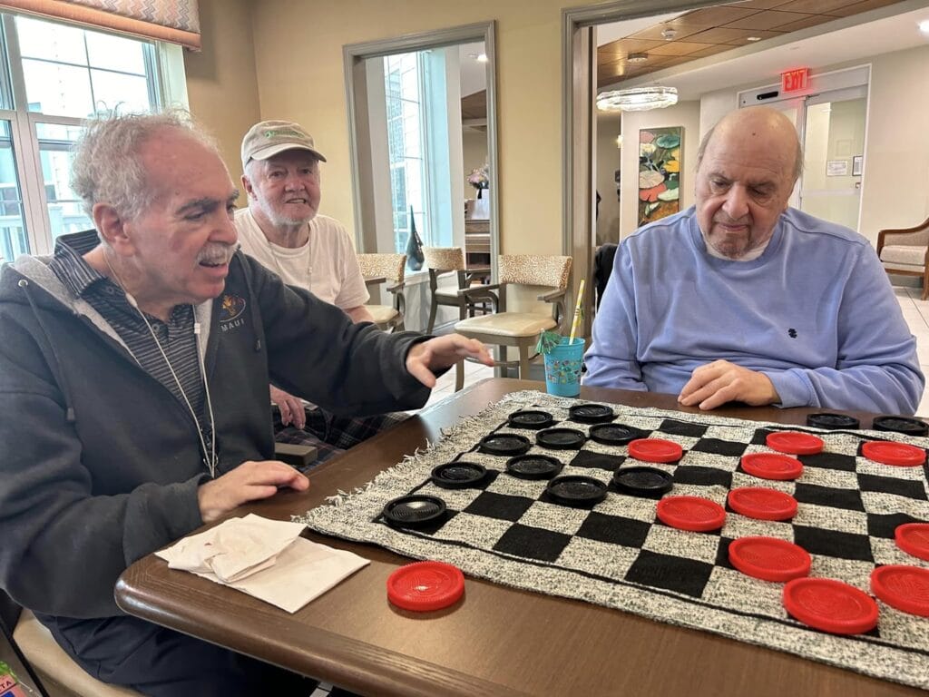 A picture of gentlemen playing checkers together