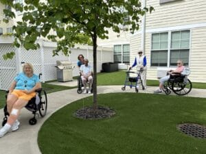 A picture of seniors on a courtyard at an independent living facility