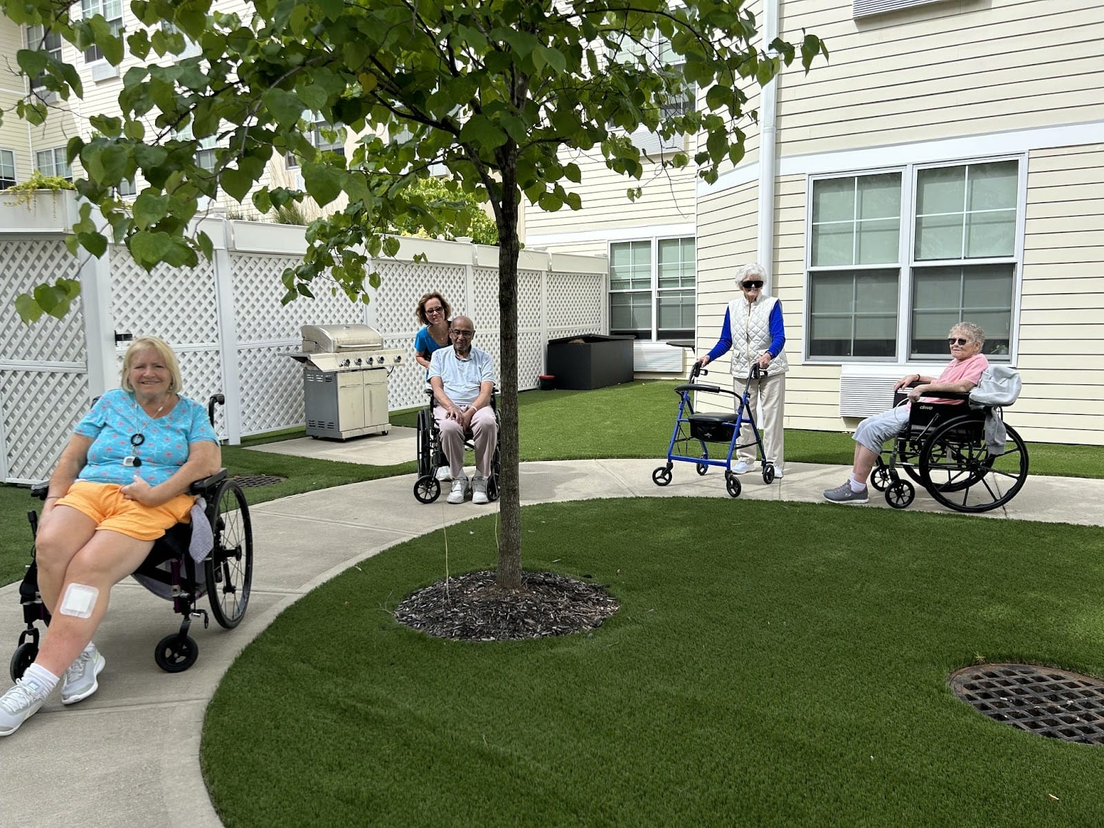 A picture of seniors on a courtyard at an independent living facility