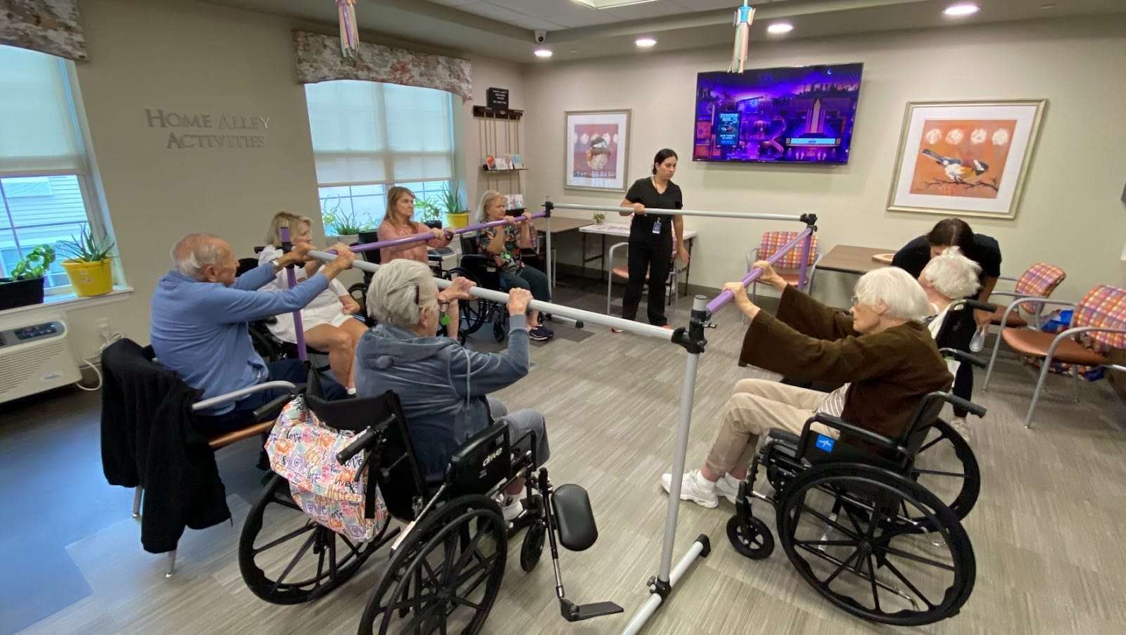 A picture of seniors in wheelchairs at a group exercise and stretching class