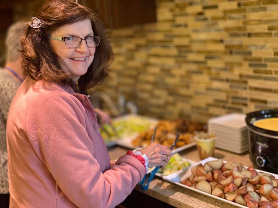 A woman at a buffet eating food