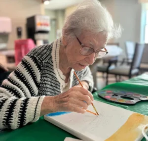 Senior woman painting art class