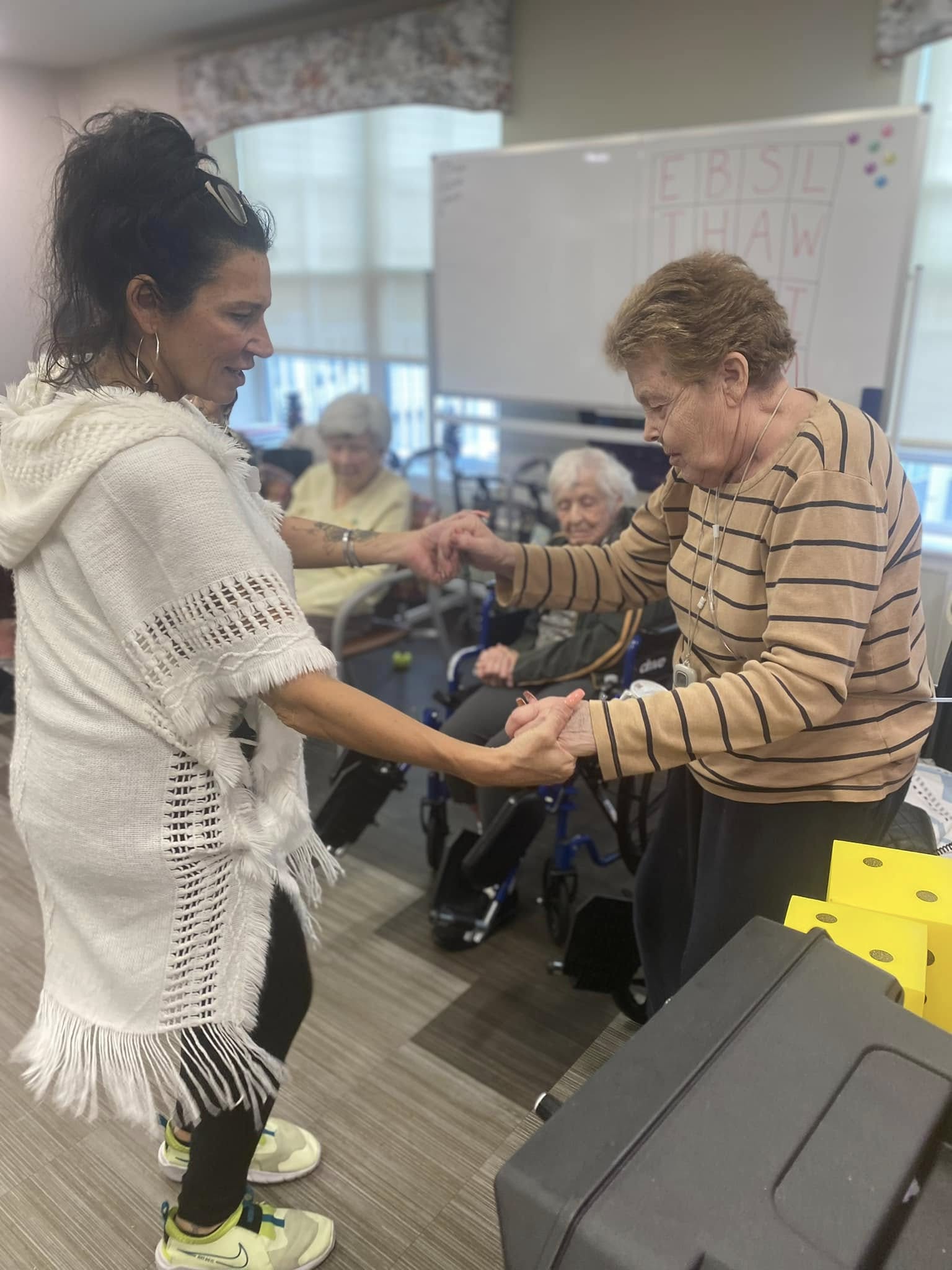 A woman dancing with a person with dementia