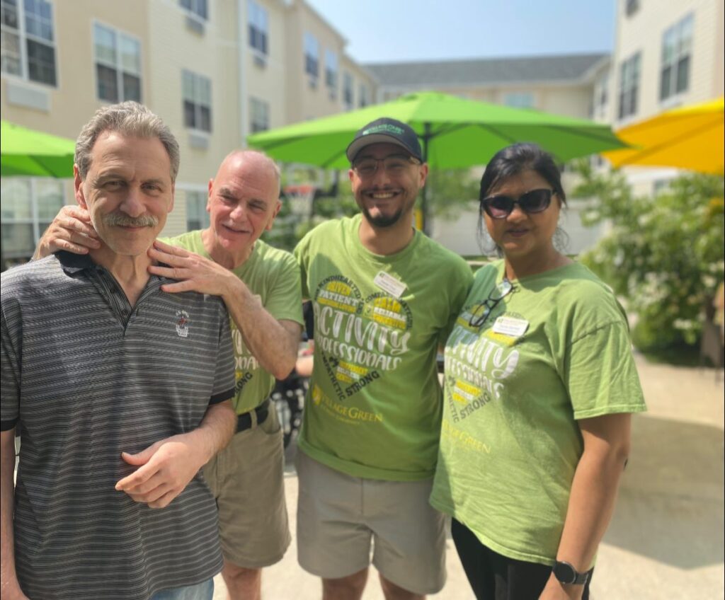 Village Green staff hanging out outdoors together with Village Green residents