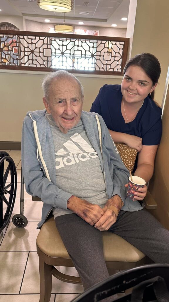 A picture of two people smiling in a senior living facility